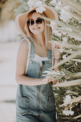 Poster - Outdoor fashion portrait of stylish woman casual outfit walking in the city.