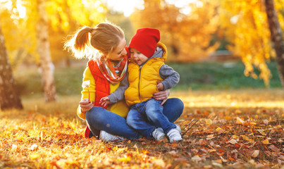 happy family  mother   and baby son on   autumn walk