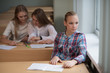 © Evgeny Sumin - student girls are sitting at a Desk