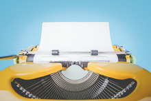 Retro Old Yellow Typewriter With Paper On Blue Background. Front Mint