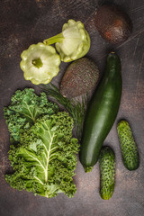 Assortment of green vegetables on a dark background, top view. Fruits and vegetables containing chlorophyll.