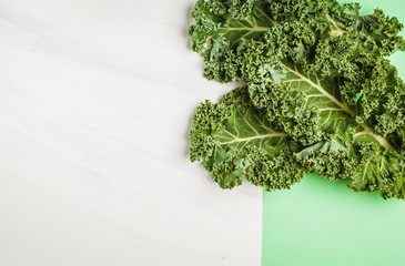 Wall Mural - Leaves of kale on a white green background. Top view, copy space.