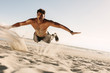 © Jacob Lund - Man doing fitness exercise in beach sand