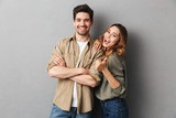 Fototapeta  - Portrait of a cheerful young couple standing together