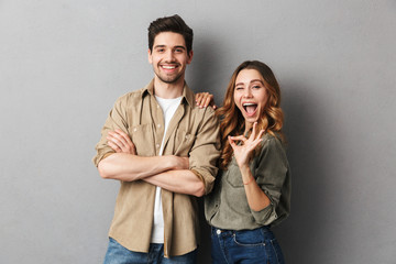 Wall Mural - Portrait of a cheerful young couple standing together