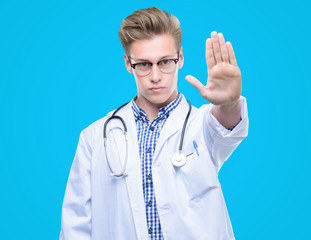 Poster - Young handsome blond doctor with open hand doing stop sign with serious and confident expression, defense gesture