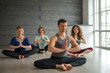 Handsome young muscular man, yogi teacher conducting yoga to caucasian women. Group training. Healthy lifestyle concept.