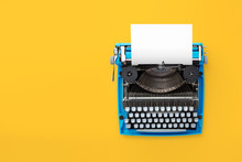 Typewriter Machine In Retro Style On Yellow Background. Top View.