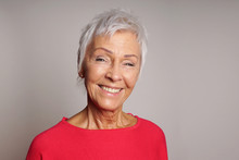 Happy Smiling Mature Woman In Her Sixties With Trendy White Short Hair