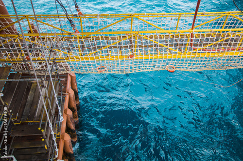 Fotografie, Obraz View of an offshore crew walking at the gangway to offshore drilling rig with li