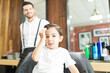 © AntonioDiaz - Fashionable Boy Touching Hair After Haircut In Barber Shop