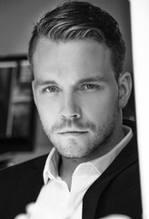 Portrait of handsome man with white shirt and blazer looking at camera