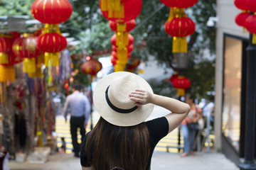 Tourist is walking and traveling on the street in Hong Kong travel district with decoration by Chinese lanterns beautiful sign.