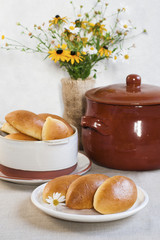 Wall Mural - Pirozhki - baked  buns made from yeast dough and glazed with eggs, with cabbage and tomatoes filling, typical for Russia and Ukraine.