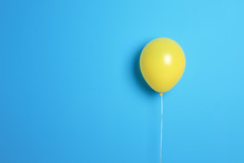 Yellow Balloon On Color Background. Celebration Time