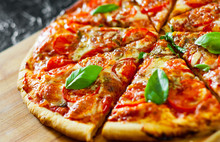 Sliced Pizza With Mozzarella Cheese, Tomatoes, Pepper, Spices And Fresh Basil. Italian Pizza. Pizza Margherita Or Margarita