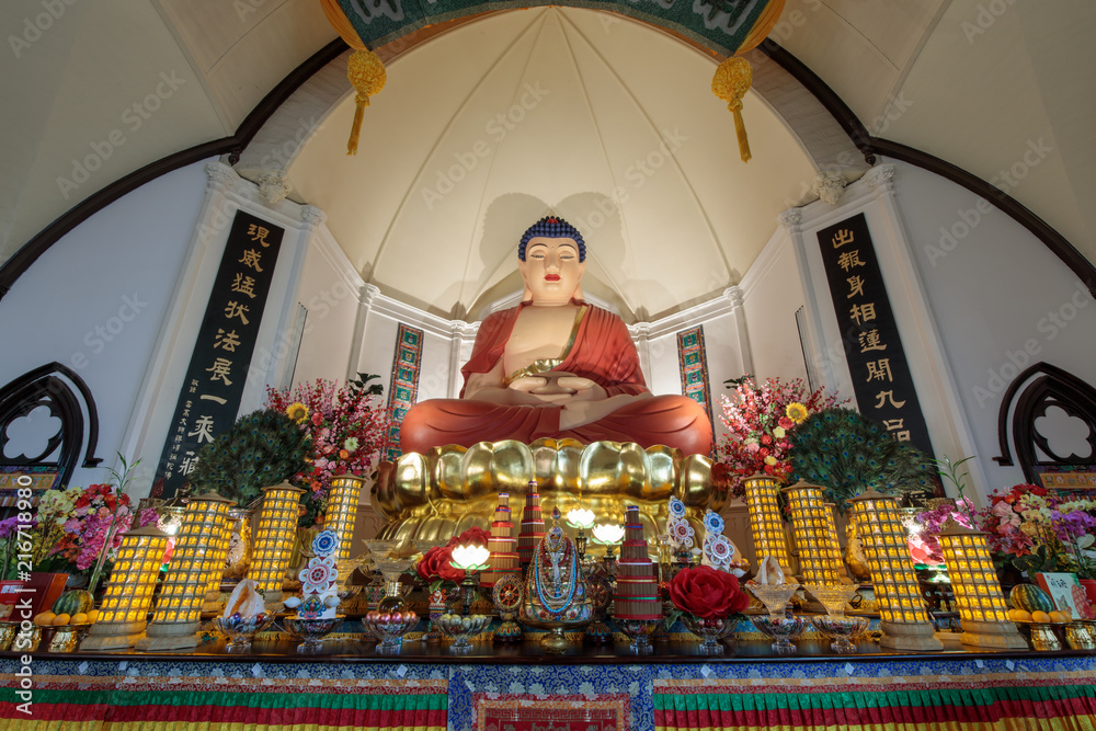 The twenty-one foot high sitting statue of Amitabha Buddha in Hua Zang Si Buddhist Temple is extremely dignified-looking and has amazed the world.  - obrazy, fototapety, plakaty 
