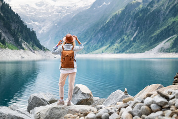 Wall Mural - Traveler look at the mountain lake. Travel and active life concept. Adventure and travel in the mountains region in the Austria