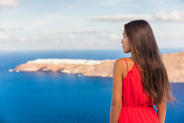 Fototapete - Santorini greece travel luxury destination Asian woman beauty at Oia landscape background. Tourist girl on holiday.