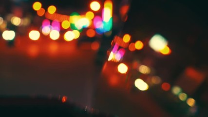 Canvas Print - Blurred background of road traffic on night street in town. Bokeh lights reflected in the car window