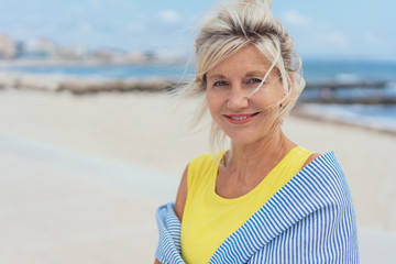 Wall Mural - Attractive pensive woman standing on a beach