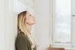 © contrastwerkstatt - Young woman standing daydreaming indoors