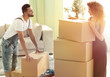 © ASDF - Happy and young couple looking at boxes