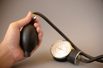 The set of Stethoscope and Sphygmomanometer or a blood pressure meter on the gray background.