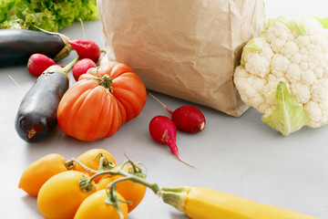 Poster - Paper bag with vegetables on gray background