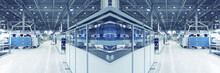Blue Toned, Blurred Collage Of As If Typical Industrial Space. Concept Of Manufacturing And Industrial Business, Industry Background. Selective Focus.Wide Panoramic Image.
