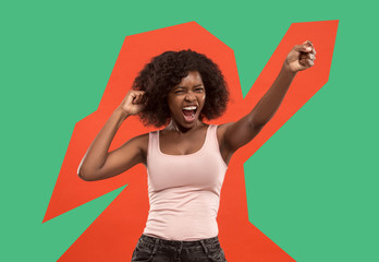 I won. Winning success happy woman celebrating being a winner. Dynamic image of caucasian female model on red studio background. Victory, delight concept. Human facial emotions concept. Trendy colors