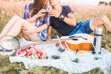 Wall Mural - happy couple in love at a picnic. two young people have a rest on the nature, have fun. Summer holidays