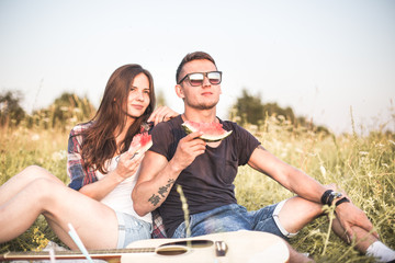 Wall Mural - happy couple in love at a picnic. two young people have a rest on the nature, have fun. Summer holidays