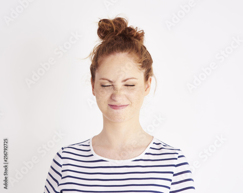 Fotografie, Tablou Portrait of girl showing feeling of disgust at studio shot