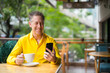 © Ranta Images - Mature Handsome Man Sitting In Coffee Shop While Using Mobile Phone
