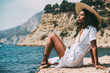 © ADDICTIVE STOCK - Woman with straw hat relaxing on beach