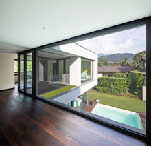 Large Window In Hallway Of Modern Villa Overlooking The Private Pool