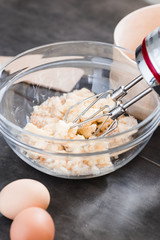 Wall Mural - MIxing baking ingredients in a bowl for cake or pancakes. Food photography styling concept