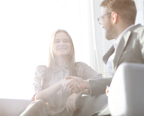 Wall Mural - background image of a handshake of colleagues in the workplace