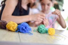 Hands Of An Adult And Hands Of A Child Knitting Together
