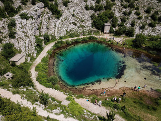 Sticker - The spring of the Cetina River (izvor Cetine) in the foothills of the Dinara Mountain is named Blue Eye (Modro oko). Cristal clear waters emerge on the surface from a more than 100 meter-deep cave.