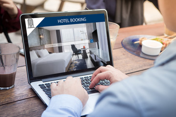 Wall Mural - businessman searching for lodging using online web service, booking a hotel on website using laptop 