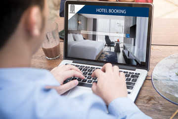 Wall Mural - young man searching for lodging using online web service, booking a hotel on website using laptop / 