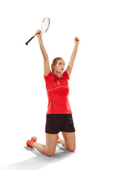 Wall Mural - Young woman after playing badminton standing as winner over white studio background. Fit female athlete isolated on white. Victory concept