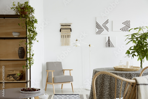 Real photo of an armchair with houndstooth pattern standing in the corner of a w Poster Mural XXL