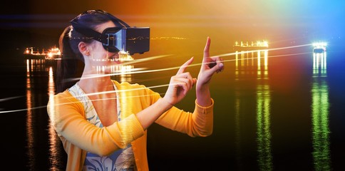 Poster - Composite image of woman using a virtual reality device