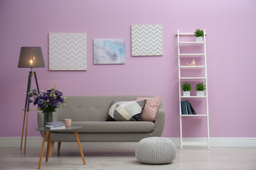 Poster - modern living room interior with comfortable gray sofa near color wall