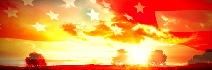 Poster - American flag rippling over landscape during sunrise