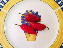 Three Red Hot Chilli Pepper Or Red Jalapeno Pepper Over A White, Blue And Yellow Ceramic Plate, Isolated Organic Food Ingredients