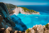 Fototapeta Most - Navagio beach, Zakynthos island, Greece. Tourist boats visiting Shipwreck bay with azure water and paradise white sand beach. Famous landmark location in the world